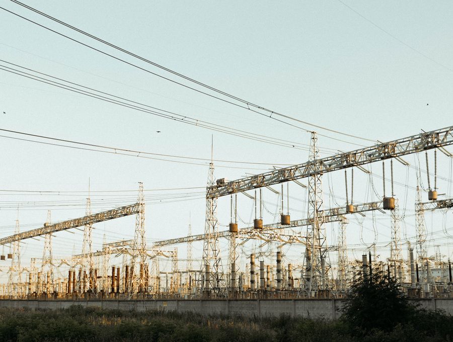 High-voltage substation switchyard in late-afternoon light